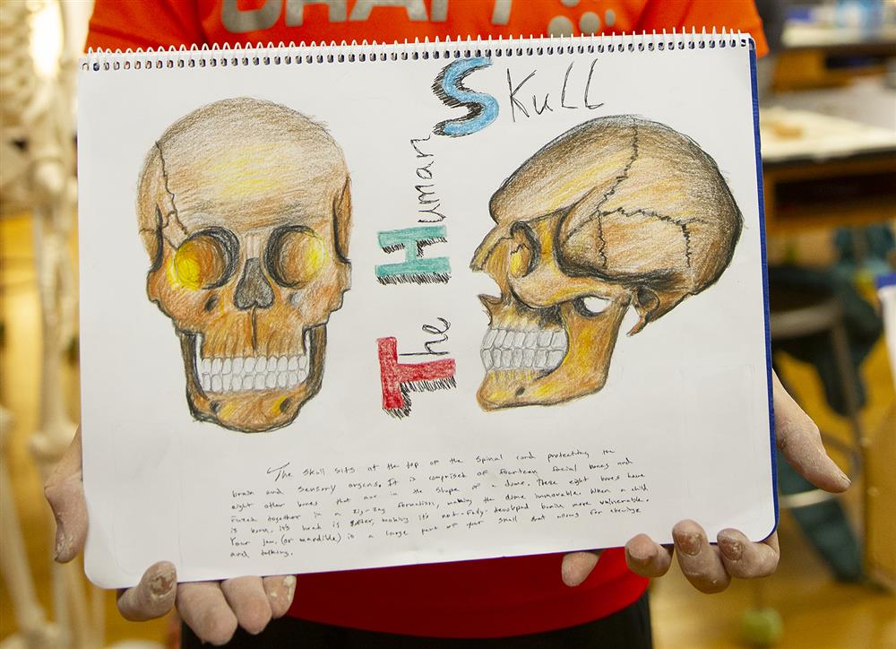 A Winterberry Charter School student holds up his Main lesson Book. 